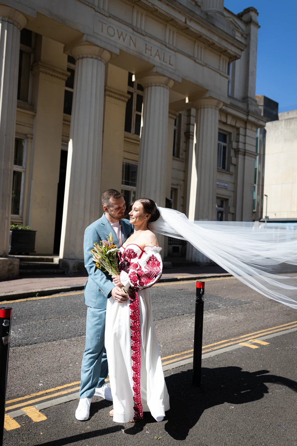 Lena and Arturs outside the Town Hall, with Lena’s veil blowing in the breeze — Brighton