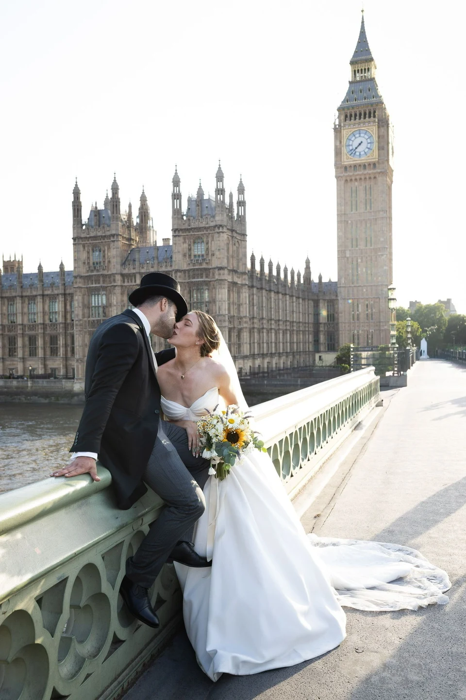Natalia and Amir kissing on Westminster Bridge with Big Ben behind them — London
